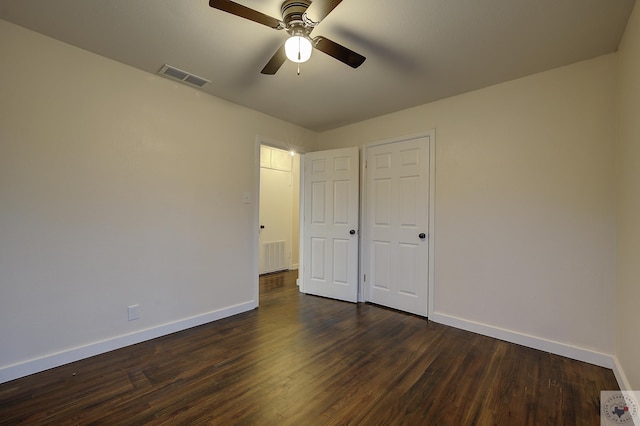 unfurnished bedroom with dark hardwood / wood-style flooring and ceiling fan