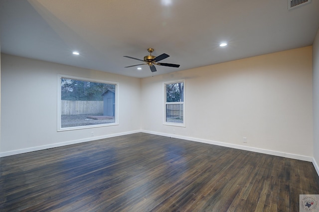 empty room with dark wood-type flooring and ceiling fan