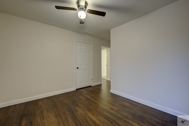 spare room featuring dark wood-type flooring and ceiling fan