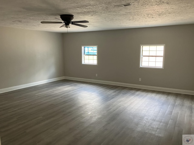 spare room with ceiling fan, dark wood-type flooring, and a textured ceiling