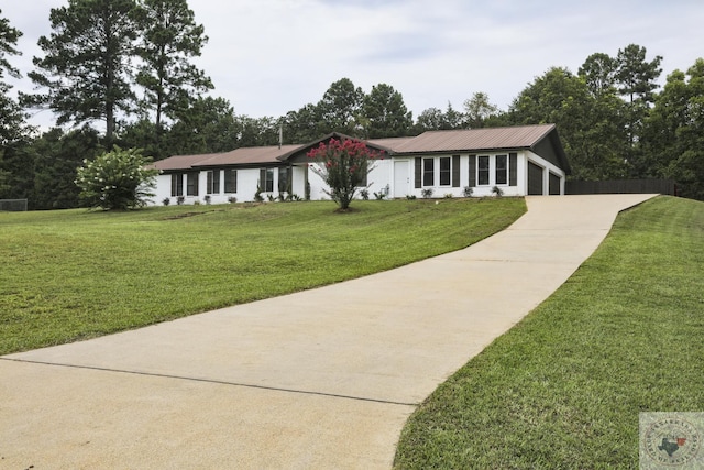 ranch-style home with a garage and a front lawn