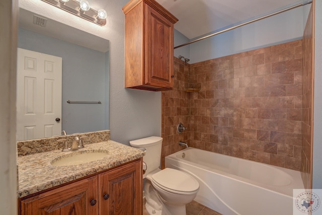 full bathroom featuring tiled shower / bath combo, vanity, toilet, and tile patterned flooring