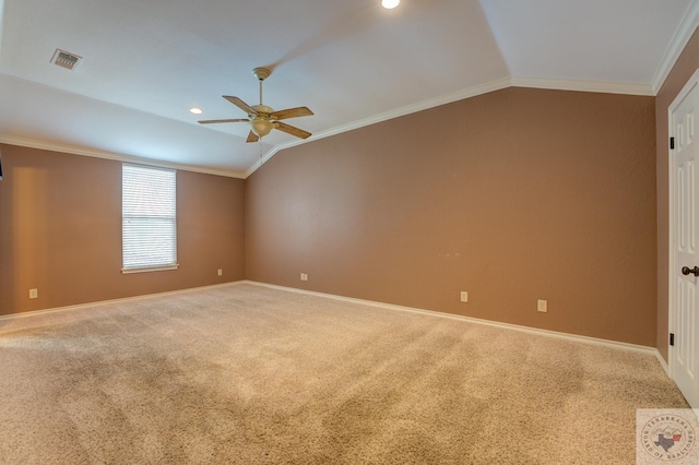 carpeted empty room featuring ceiling fan, ornamental molding, and vaulted ceiling