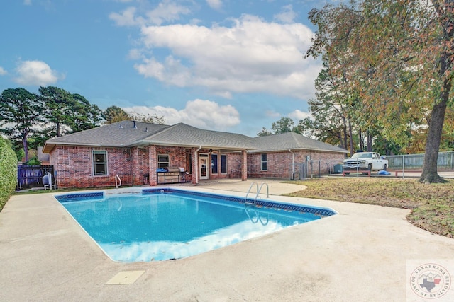 view of pool with a fenced in pool, fence, and a patio area