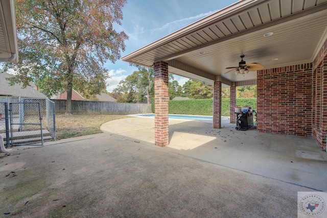 view of patio / terrace with ceiling fan and a fenced in pool