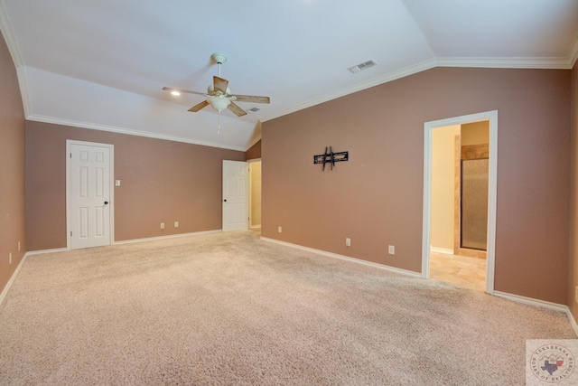 carpeted empty room with ceiling fan, crown molding, and lofted ceiling