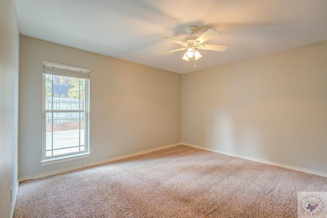 empty room featuring ceiling fan and carpet floors