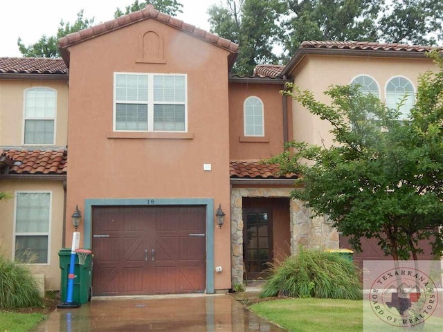 mediterranean / spanish-style house with a garage