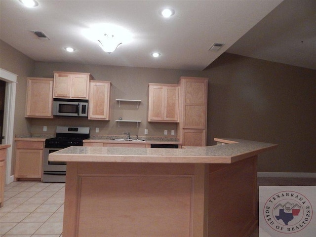 kitchen featuring light brown cabinetry, appliances with stainless steel finishes, sink, light tile patterned floors, and a center island