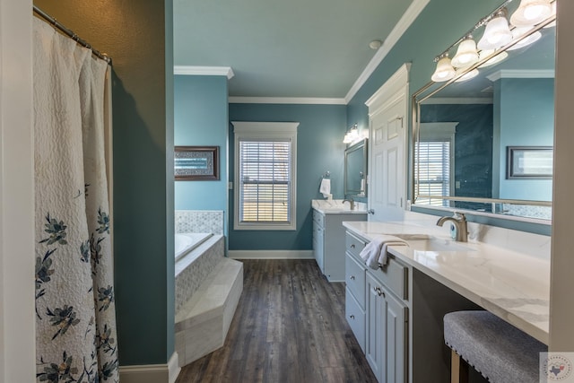 bathroom featuring a relaxing tiled tub, hardwood / wood-style floors, vanity, and crown molding