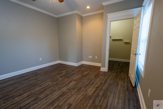 unfurnished room with crown molding, ceiling fan, and dark hardwood / wood-style flooring