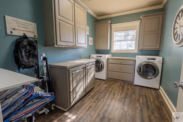 laundry area with dark wood-type flooring, cabinets, crown molding, and washing machine and dryer