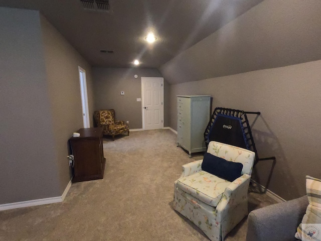 sitting room featuring light colored carpet and vaulted ceiling