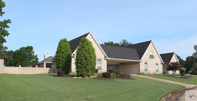 view of front of property featuring a garage and a front lawn