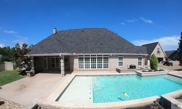 view of pool with a patio and a hot tub