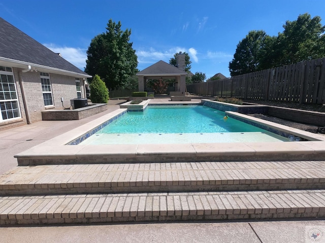 view of pool featuring a gazebo, central AC, a jacuzzi, and a patio