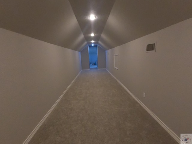 interior space featuring lofted ceiling and carpet flooring