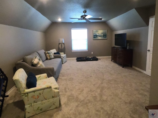 interior space with ceiling fan, a textured ceiling, lofted ceiling, and carpet flooring