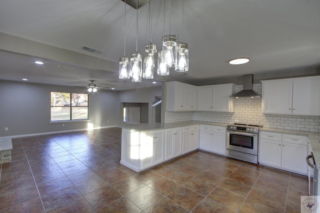 kitchen with pendant lighting, white cabinets, electric range, and wall chimney range hood