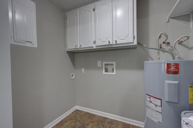 washroom with a textured ceiling, hookup for a washing machine, electric panel, cabinets, and water heater