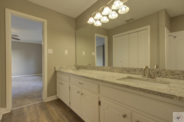 bathroom featuring ceiling fan, hardwood / wood-style floors, and vanity