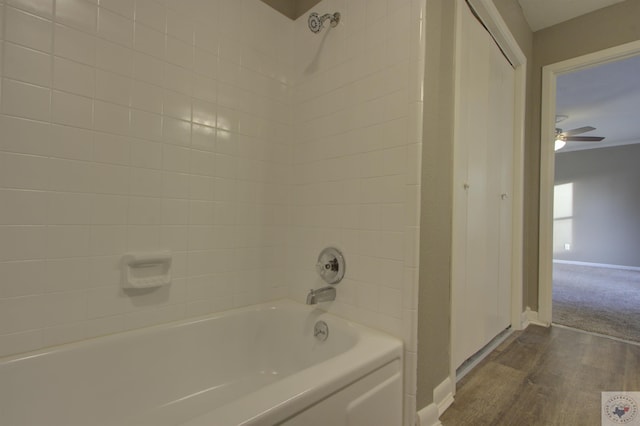 bathroom with ceiling fan, hardwood / wood-style floors, and tiled shower / bath combo