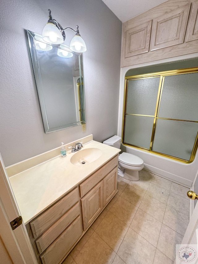 full bathroom with toilet, shower / bath combination with glass door, tile patterned floors, and vanity