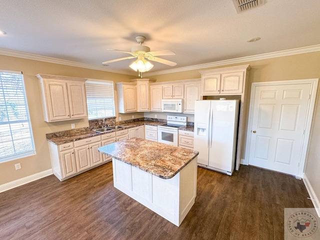 kitchen featuring sink, white appliances, crown molding, and plenty of natural light