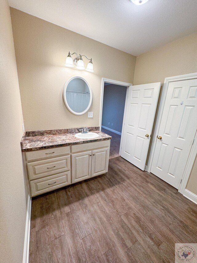 bathroom featuring vanity and hardwood / wood-style flooring