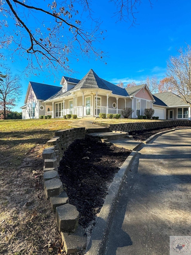 ranch-style home featuring a porch and a garage