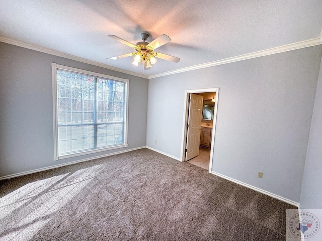 unfurnished bedroom with ceiling fan, light colored carpet, ensuite bath, and ornamental molding