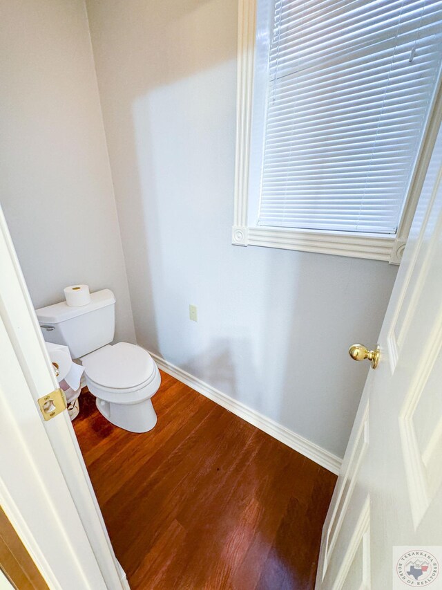 bathroom featuring hardwood / wood-style flooring and toilet