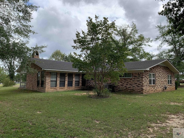 rear view of property featuring a yard