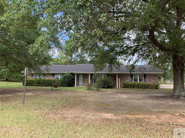 ranch-style home with a front lawn and brick siding