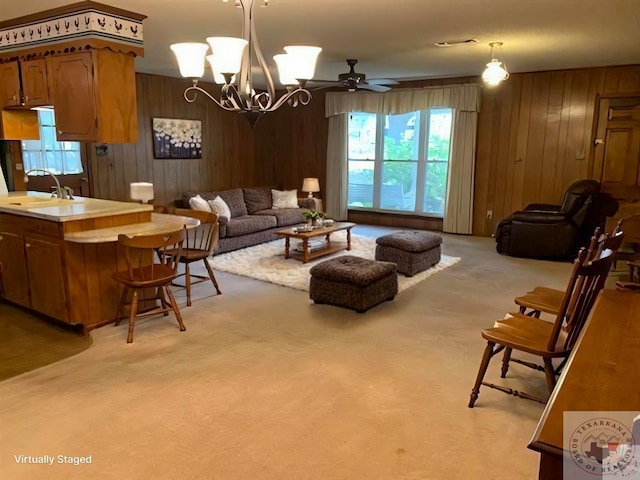 living area featuring wooden walls and light colored carpet