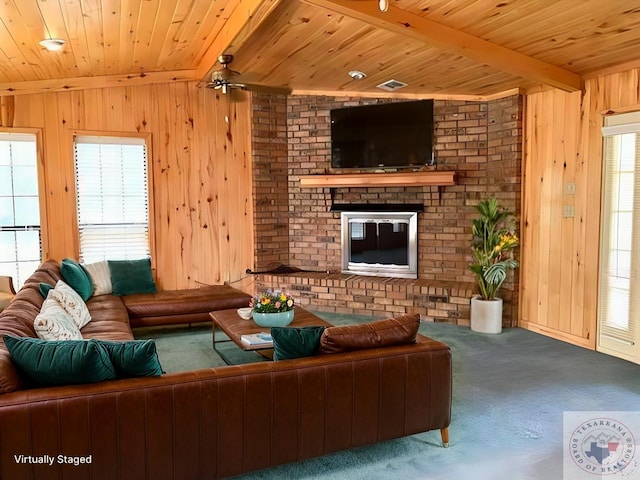 carpeted living area featuring beamed ceiling, visible vents, wooden walls, wooden ceiling, and a fireplace