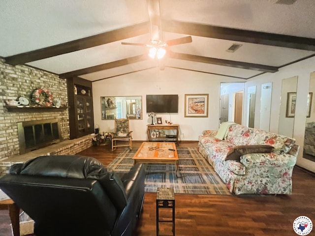 living room featuring lofted ceiling with beams, a brick fireplace, visible vents, ceiling fan, and wood finished floors