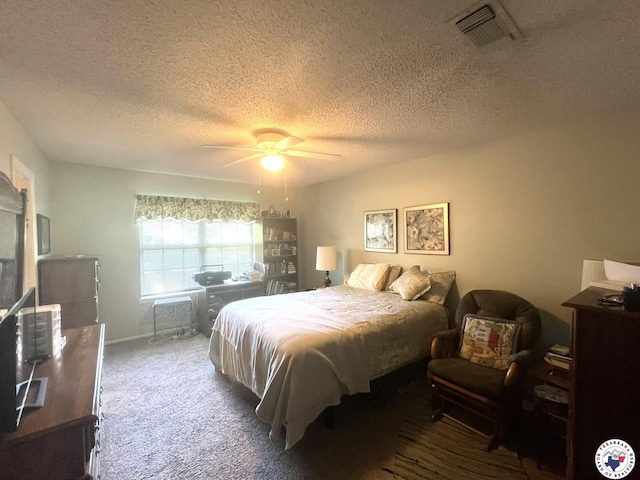 bedroom with visible vents, ceiling fan, carpet floors, and a textured ceiling