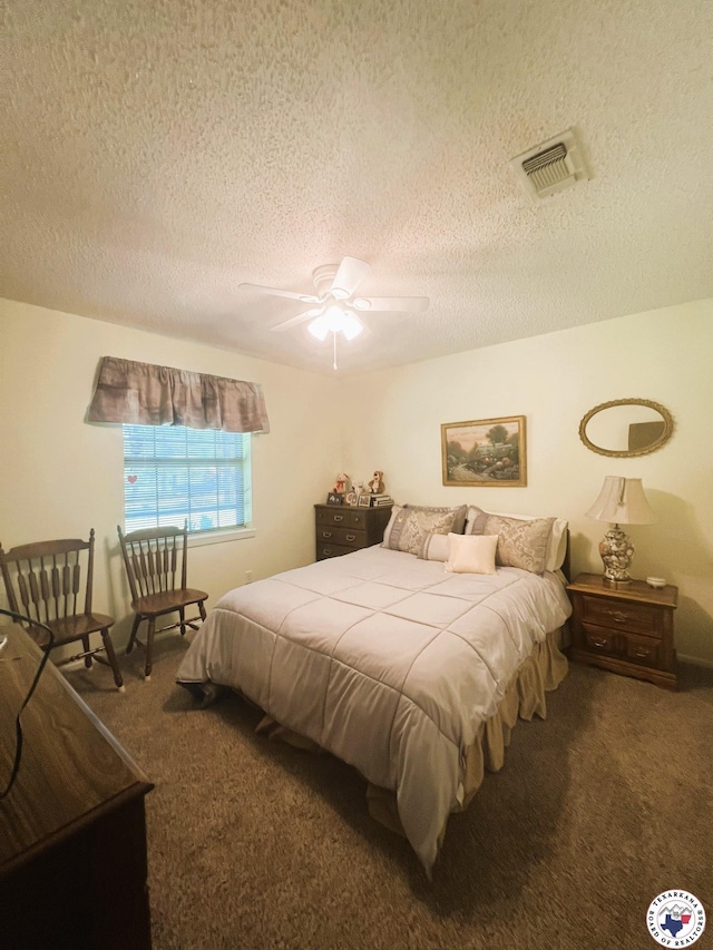 carpeted bedroom with visible vents, a textured ceiling, and ceiling fan