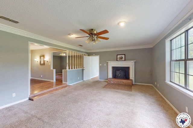 unfurnished living room with carpet floors, ceiling fan, visible vents, and ornamental molding