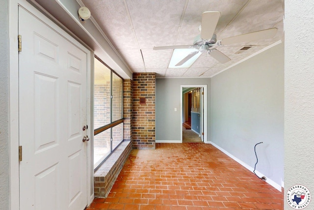 interior space featuring baseboards, brick floor, and visible vents