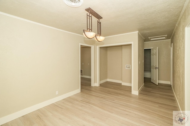 spare room featuring light hardwood / wood-style flooring and crown molding