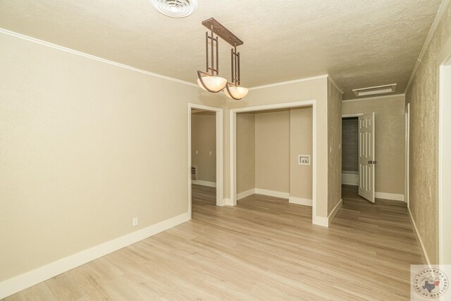 spare room featuring light hardwood / wood-style flooring and crown molding