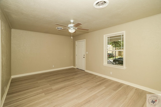 spare room with ceiling fan, light hardwood / wood-style floors, and a textured ceiling