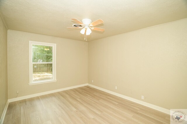 unfurnished room featuring ceiling fan, ornamental molding, and light wood-type flooring