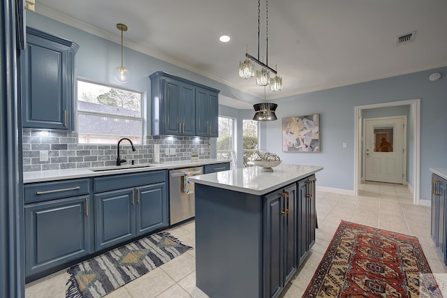 kitchen featuring visible vents, a center island, dishwasher, blue cabinets, and a sink