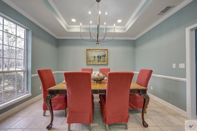 dining area with a tray ceiling, a notable chandelier, baseboards, and visible vents