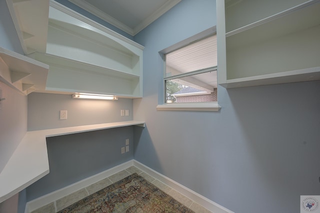 laundry area featuring tile patterned flooring, baseboards, and ornamental molding