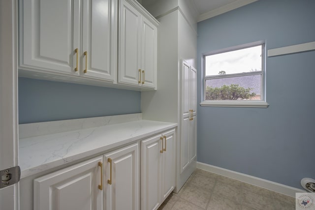 laundry room with baseboards and ornamental molding