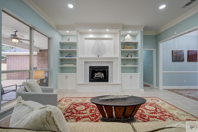 living area with built in shelves, a fireplace, and ornamental molding